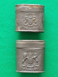 Side view of the two 1858 tins shown to left